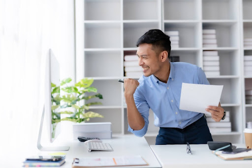 Man Using Standing Desk For Work