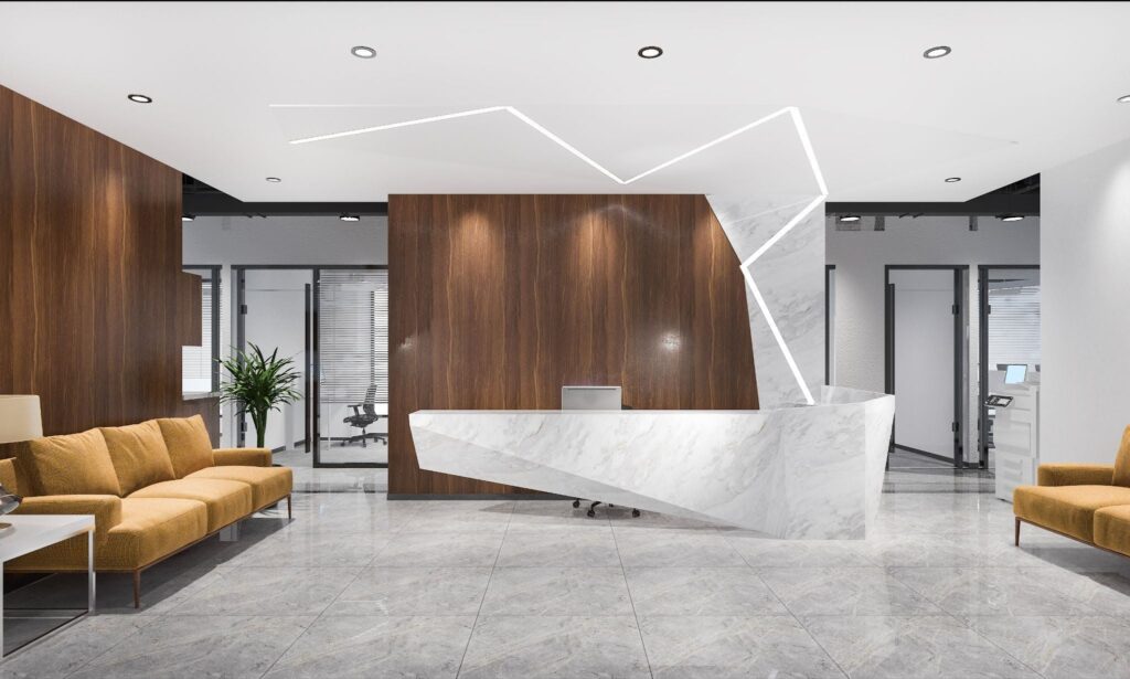 modern office reception area features a geometric white marble desk