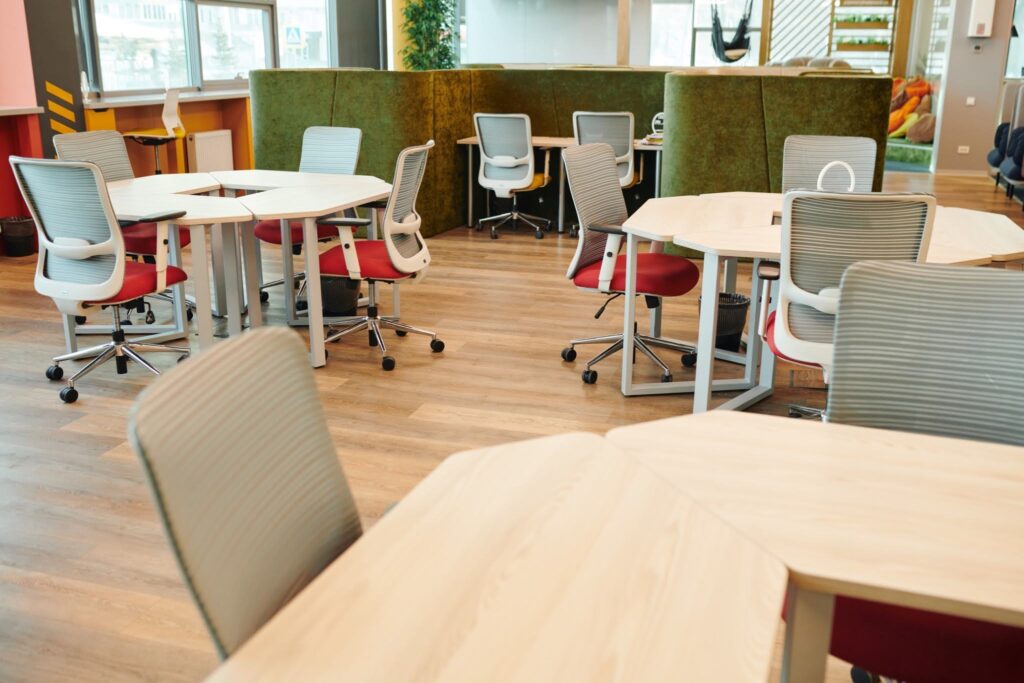 Modern open-plan office workspace with modular desks and ergonomic mesh chairs