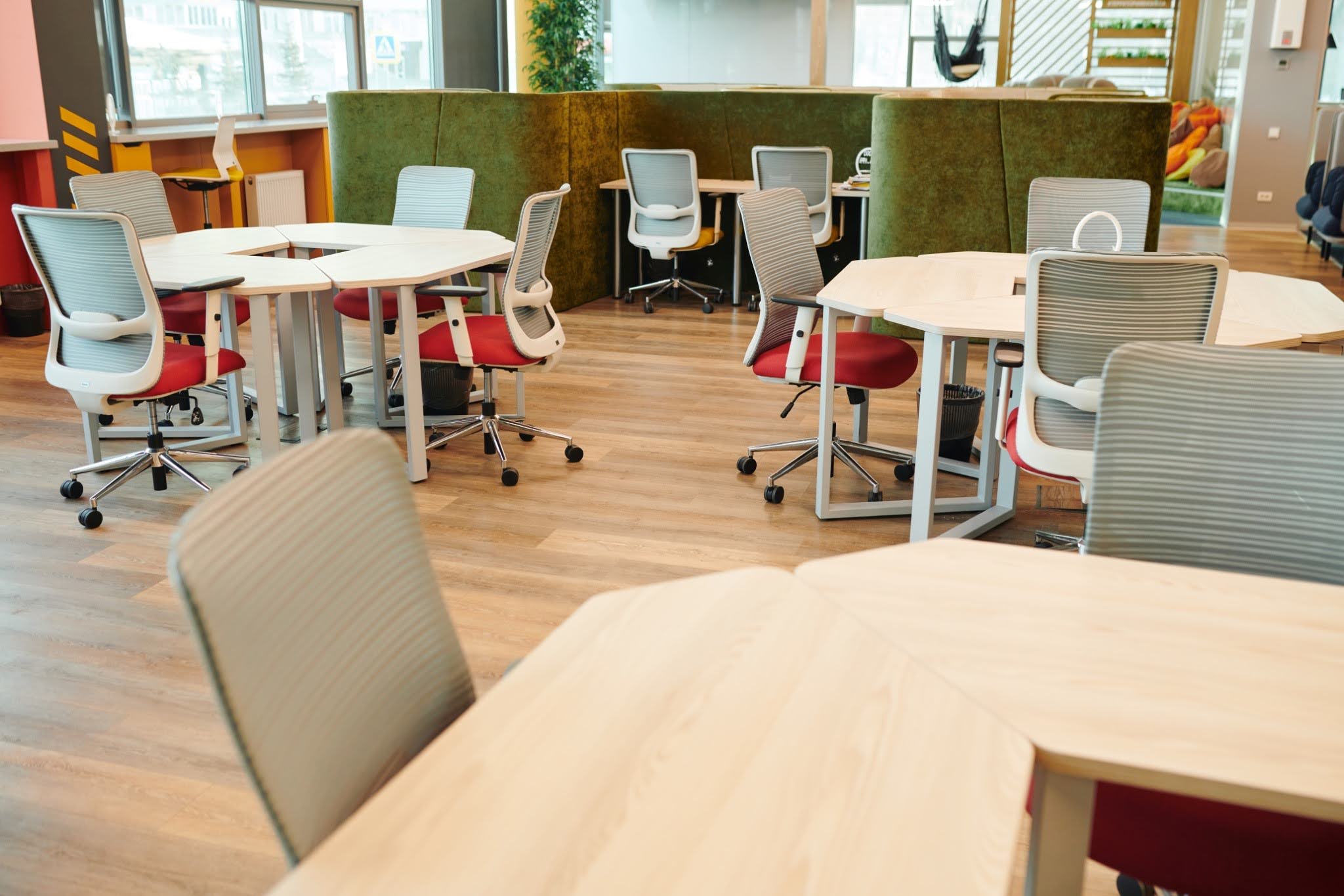 Modern open-plan office workspace with modular desks and ergonomic mesh chairs