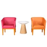 Pink and orange Honde armchairs with wood legs and a side table