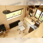 A high-angle view of a modern home office, with a light grey Senator Qdos High Back Chair positioned at a wooden desk